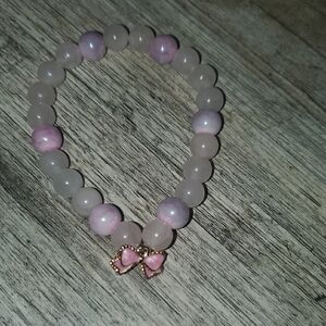 Handmade by my daughter. Pink Beaded Bracelet with Bow Charm.